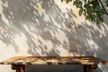 Naklejka premium Minimalist Wooden Tabletop with Lush Leaf Shadows on Beige Wall Backdrop