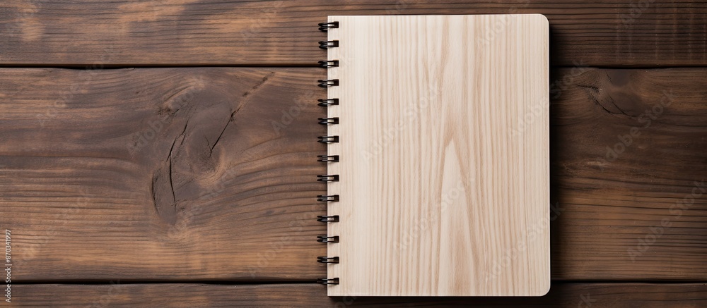 Poster Wooden background showcasing a notebook with ample copy space image.