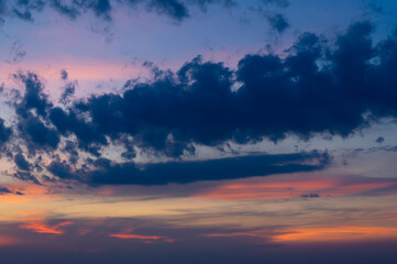 Dramatic dark moody blue and orange sunset sky. Natural background