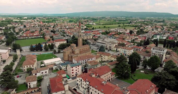 Drone Footage of Cornuda, Italy: Cityscape, Cathedral, and Bell Tower in Urban Landscape. High quality 4k footage