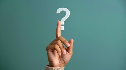 Female hand pointing at question mark on a background