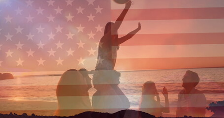 Image of american flag over diverse friends celebrating on sunset beach