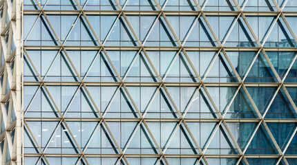 A beautiful background of an glass office building, reflecting clouds in the opened windows