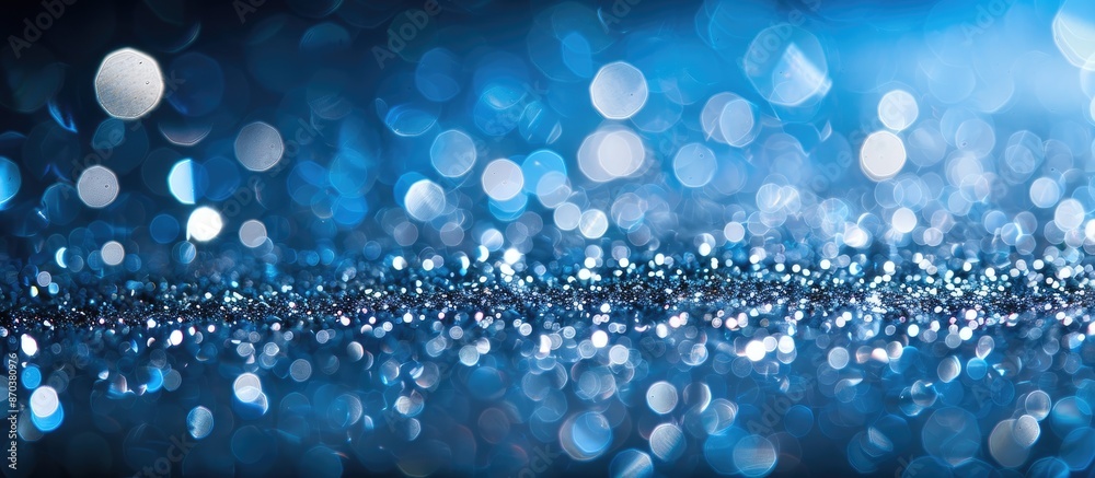 Poster abstract festive header with sparkling silver glitter on a blue background, creating a shimmering ho