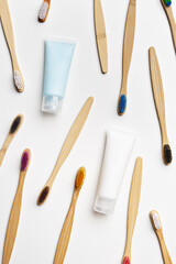 Colorful bamboo toothbrushes and white toothpaste tube, eco-friendly oral hygiene, tooth care, personal toothbrush for everyday use. Minimal style aesthetic flat lay, Zero waste, organic product