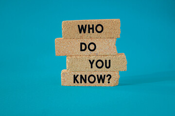 Naklejka premium Who Do You Know symbol. Concept words Who Do You Know on brick blocks. Beautiful blue background. Business and who do you know concept.