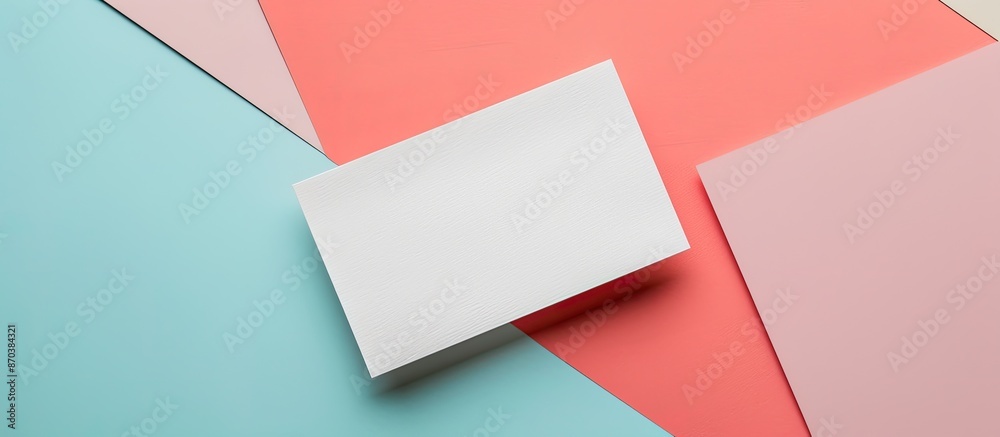 Aufkleber A blank business card mockup on a colored background in a flat lay style with designated copy space image.