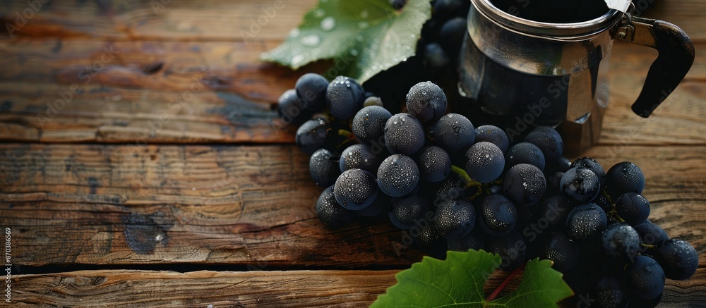 Poster black grapes on a wooden table with space for text, next to a coffee percolator. copy space availabl