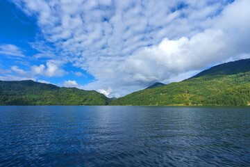  Beautiful freshwater lake view with cloudy blue-sky background—stunning view of the magical lake in the middle of the Himalayas.