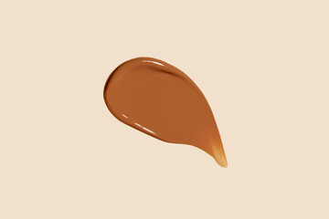 Fototapeta premium Cosmetic concealer or foundation smudge, strokes isolated on nude background