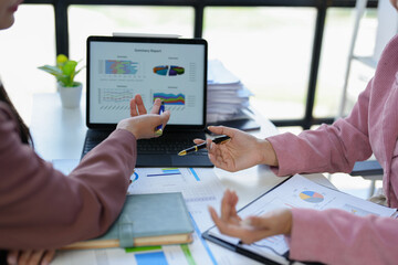 Asian female sales representatives in the section of Real estate talked and discussed tax plans to search for information Ask questions and give advice. All information is recorded and detailed.