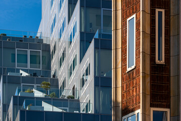 Image of a modern residential building featuring numerous balconies and extensive glass windows, highlighting contemporary urban living and architectural design in Rotterdam