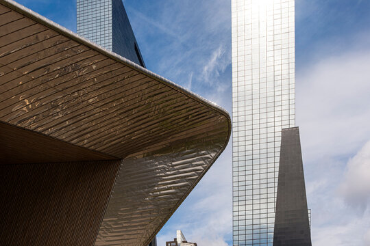 futuristic skyscraper featuring a highly reflective glass facade, showcasing modern architectural design and the advancement of urban landscapes in Rotterdam