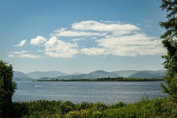 Scenic view of a lake with mountains in the background under a clear blue sky