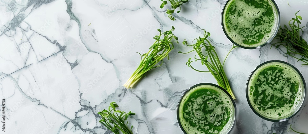 Poster a marble table showcasing glasses of wheatgrass juice with green sprouts, offering ample room for te