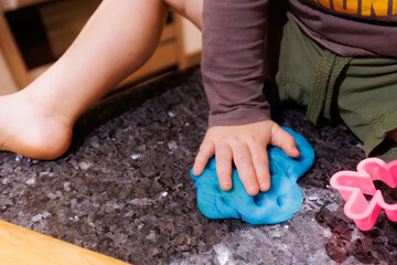 Close up of little boy's hands playing with playdough