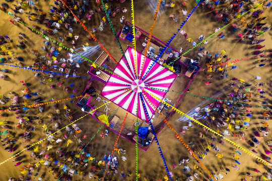 People dance at hindu Navratri festival the traditional Garba dance wearing indian clothes. Spectacular Top down aerial view of indian religious festival
