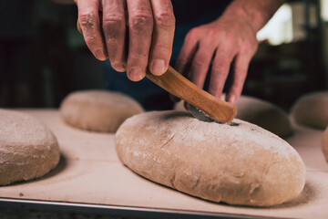 Cutting bread blank in a traditional bakery