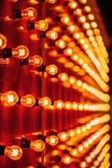 A row of lights with the letters W and M on them. The lights are lit up and the image has a warm, inviting feeling