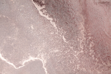 A close-up of a dusty rose sky at sunset with swirling clouds and glittering stars