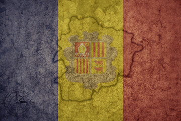 Fototapeta premium map and flag of andorra on a old vintage crack paper background .