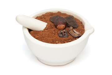 Close-up of Organic Reetha (Sapindus mukorossi) Amla (Phyllanthus emblica) and Shikakai (Acacia concinna) Powder with its Fruits, in white ceramic mortar and pestle, isolated on a white background.