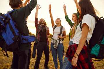 Tourist people high five greeting salutation, outdoor hiking travelling group before, after walking trail. Friends enjoy happy backpack tour, recreational activity, environment journey, discovery