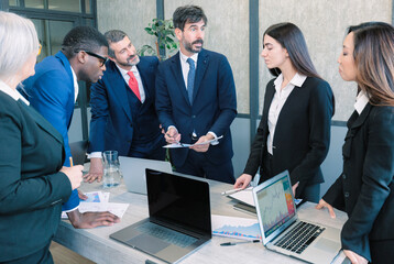 Business people discussing a project in an office. Teamwork and collaboration in a creative workplace.