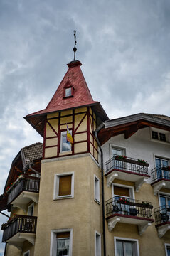 Blick auf den Eckturm eines alten Hauses mit Fachwerkbau im oberen Bereich und hutf&ouml;rmigem Dach mit kunstvollem Blitzableiter auf der Dachspitze