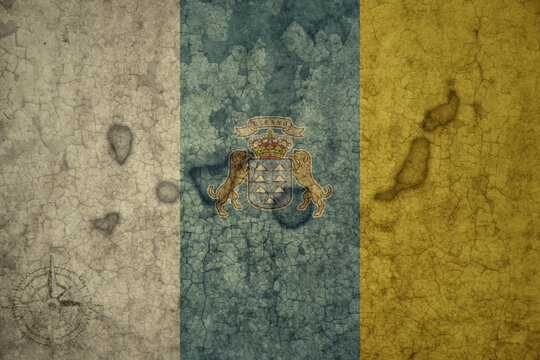 map and flag of canary islands on a old vintage crack paper background .