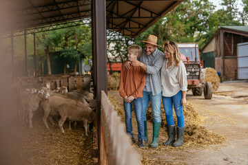 A kid having a great field day at a farm with his parents