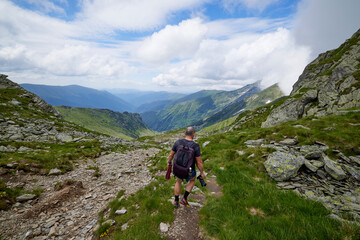 Fototapeta premium A middle-aged man walking on the mountain