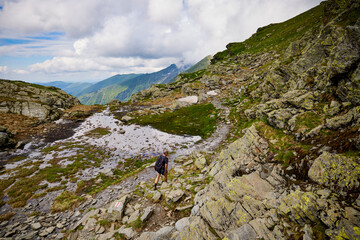 A middle-aged man walking on the mountain