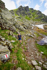 Fototapeta premium A middle-aged man walking on the mountain