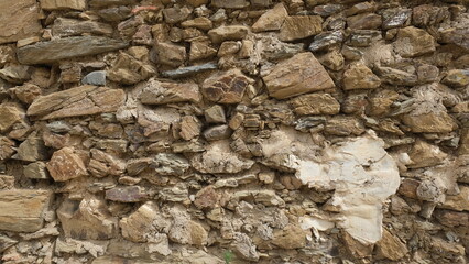 Textured wall. Rural construction area. Old form of housing