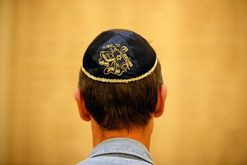 Man wearing Jewish kippah in a synagogue.