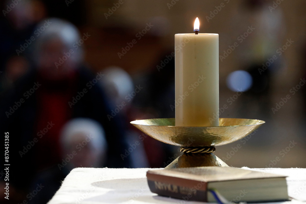 Wall mural saint-jacques church. catholic mass. church candle and roman missal on an altar. sallanches. france.