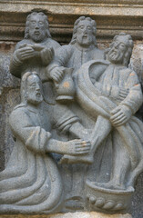 Calvary of Guimiliau. Jesus washes the feet of Saint Peter. France.