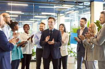 A group of business people at a meeting in a business center. Office team celebrates success through collaboration, unity, and professionalism, staying motivated and supportive.