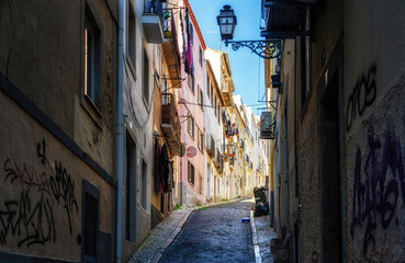 Fototapeta premium View of steep narrow Lisbon streets at medieval quarter Alfama