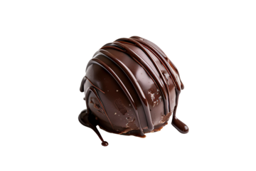a chocolate covered round object with drizzled liquid