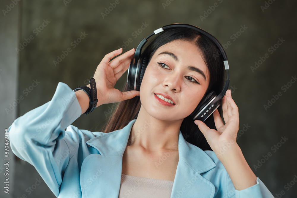 Wall mural beautiful young woman is happy while listening to music in a coffee shop