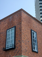 Obraz premium White windows in the red wall of the building