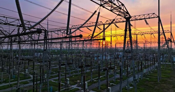 High voltage power tower in substation. Transmission power line at dusk. 