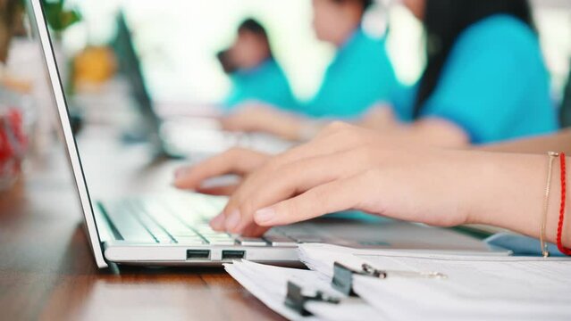 Hand of a woman typing on laptop keyboard, in the office
