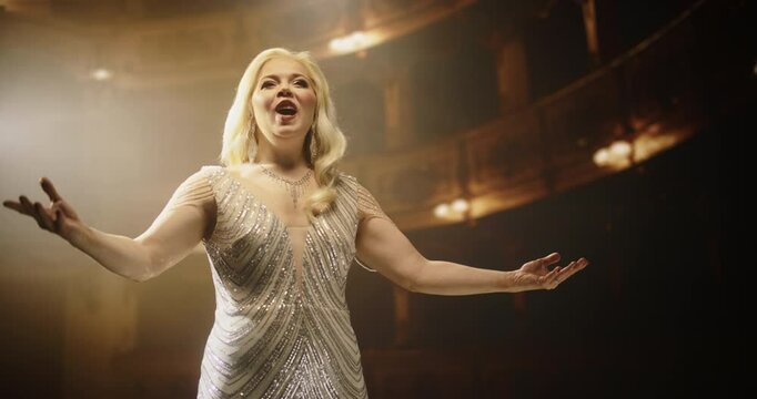 Talented Female Opera Singer With Blonde Hair and Outstretched Arms, Performing for Music Fans on a Historic Stage. Her Passionate Performance and Powerful Voice Leave a Lasting Impression