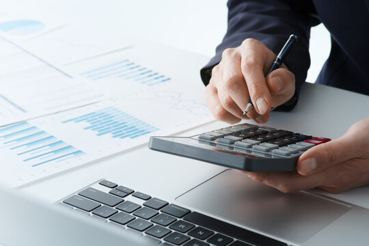 Business financial analysis. Businessman calculating budget. Many reports and calculator.
