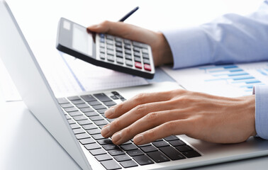 Investigating business financial health. Businessman calculating cash flow. Many reports and...