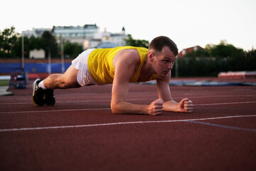 Athlete doing plank exercise before race