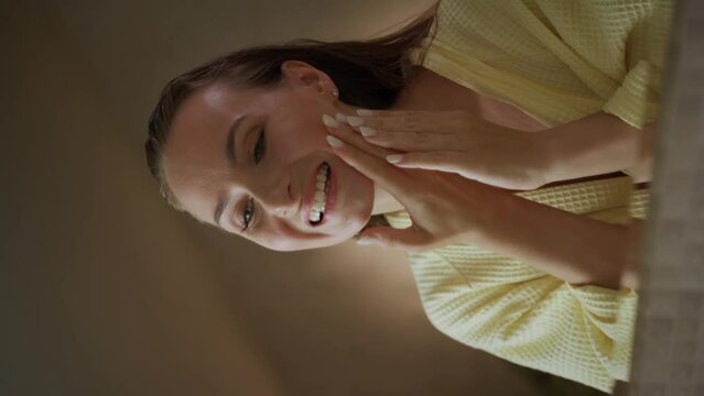 A woman who has a toothache in the morning. She holds her cheek and winces in pain. These frames can be used to illustrate the discomfort and pain associated with dental problems